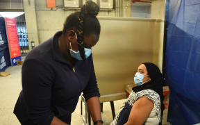 CAPE TOWN, SOUTH AFRICA - NOVEMBER 30: People receive a dose of Covid-19 vaccines following the detection of the new omicron variant of the coronavirus, at a vaccination station in Cape Town, South Africa on November 30, 2021.