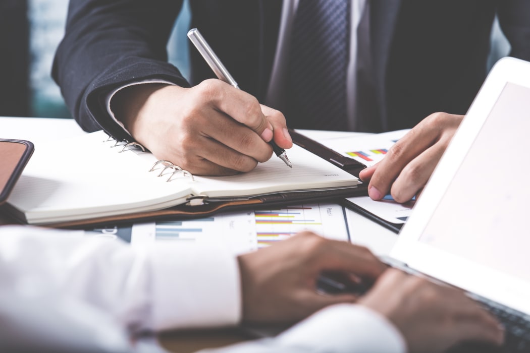 Business adviser analyzing financial figures denoting the progress in the work of the company