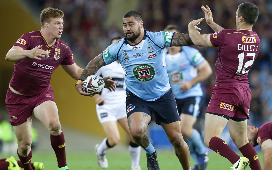 New South Wales' Andrew Fifita brushes off Queensland defenders.