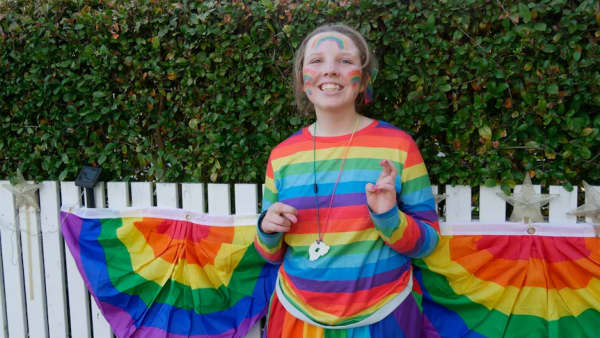Hannah Anderson-Marshall is a smiling young girl in a rainbow outfit.