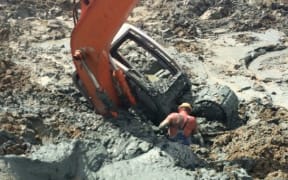 A borrowed digger got stuck in the wetland while digging the illegal pond.