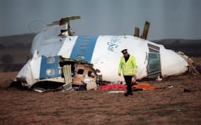 A policeman walks away from the cockpit of the Pan Am airline plan that exploded and crashed over Lockerbie, Scotland, 22 December, 1988.