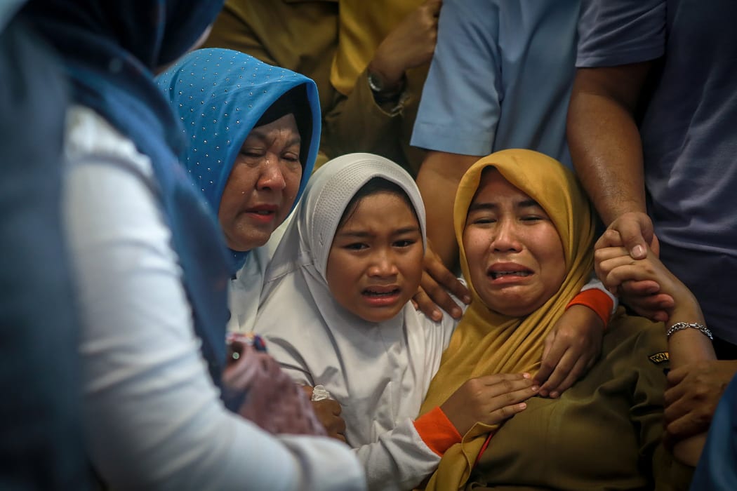 Family members of the crashed Indonesian Lion Air JT-610 react at Pangkal Pinang airport.