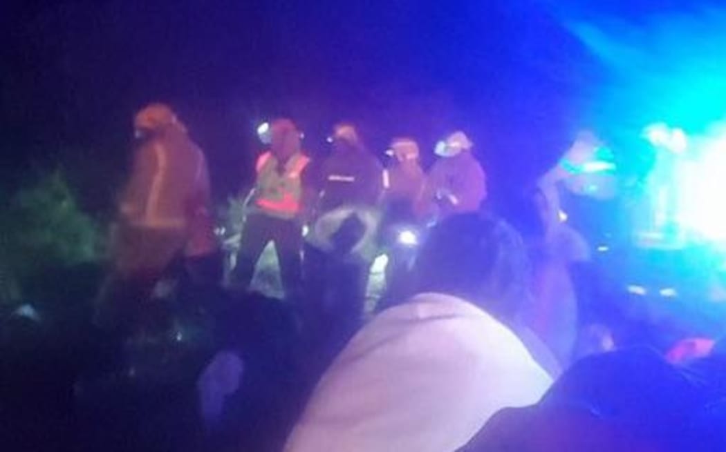 Emergency services at the scene of the bus crash south of Gisborne that claimed two lives.