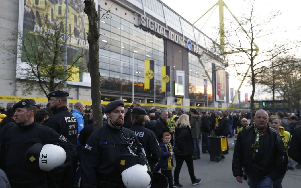 Police patrol outside the stadium after an explosion of the team bus of Borussia Dortmund.