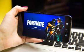 Tula, Russia - JANUARY 29, 2019 - Fortnite video game screen with character and console controller. Fortnight Battle Royale online gaming by Epic Games
