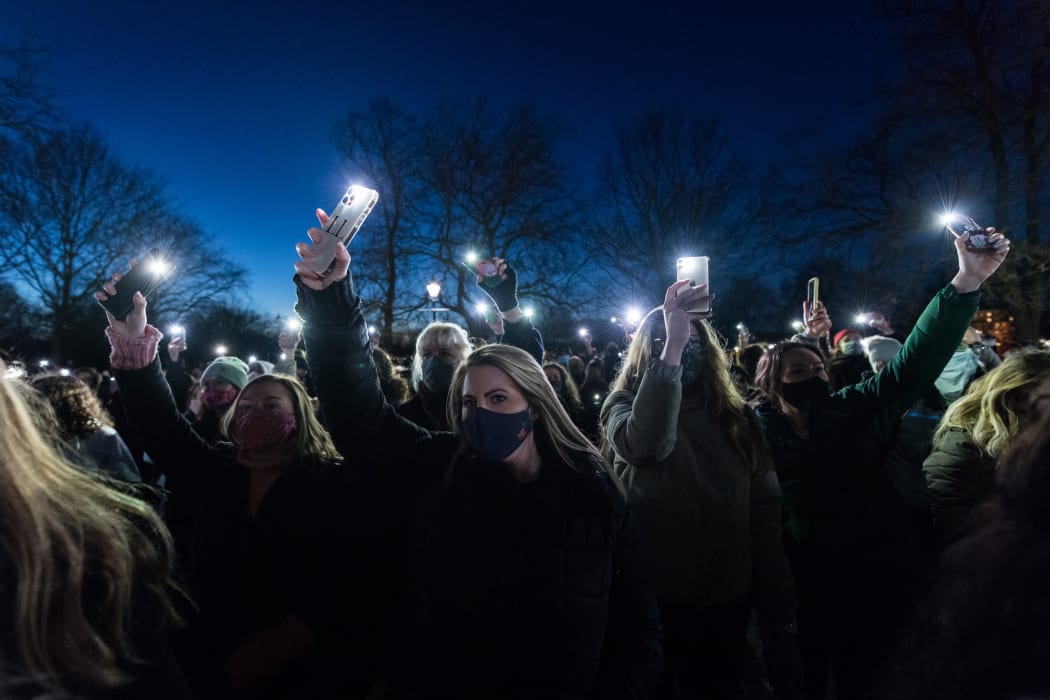 People shine their phones on Clapham Common in memory of Sarah Everard, who was kidnapped and murdered while she was walking home.