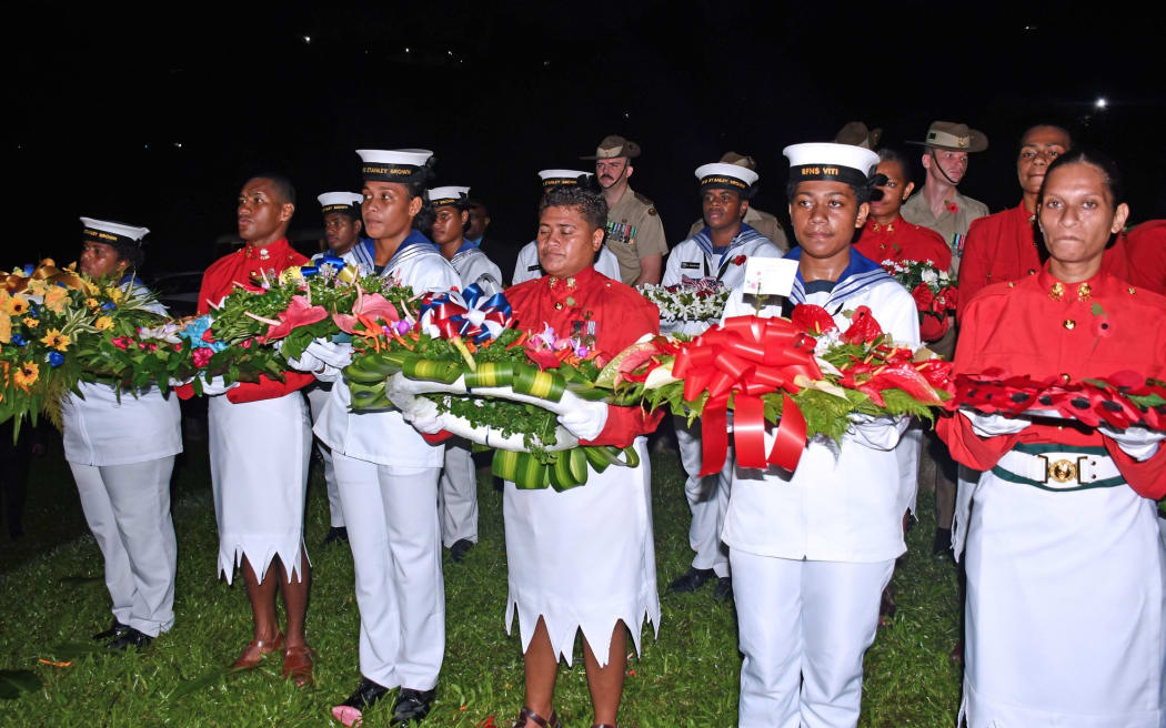 Members of the armed forces with wreaths.