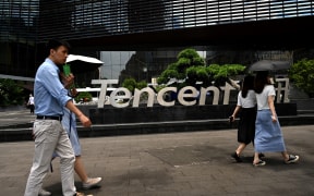 People walking past the Tencent headquarters in the southern Chinese city of Shenzhen, in Guangdong province.