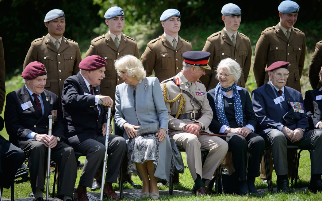 Prince Charles and the Duchess of Cornwall meet glider pilot veterans in Benouville, northern France.