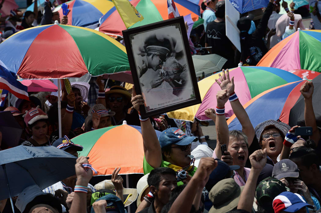 A protester holds a picture of King Bhumibol Adulyadej during Saturday's rally.