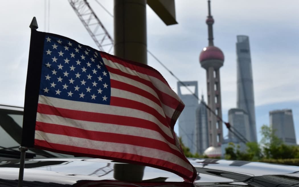 A US flag flying on a US consulate car with the backdrop of buildings in the Lujiazui financial district in Shanghai.