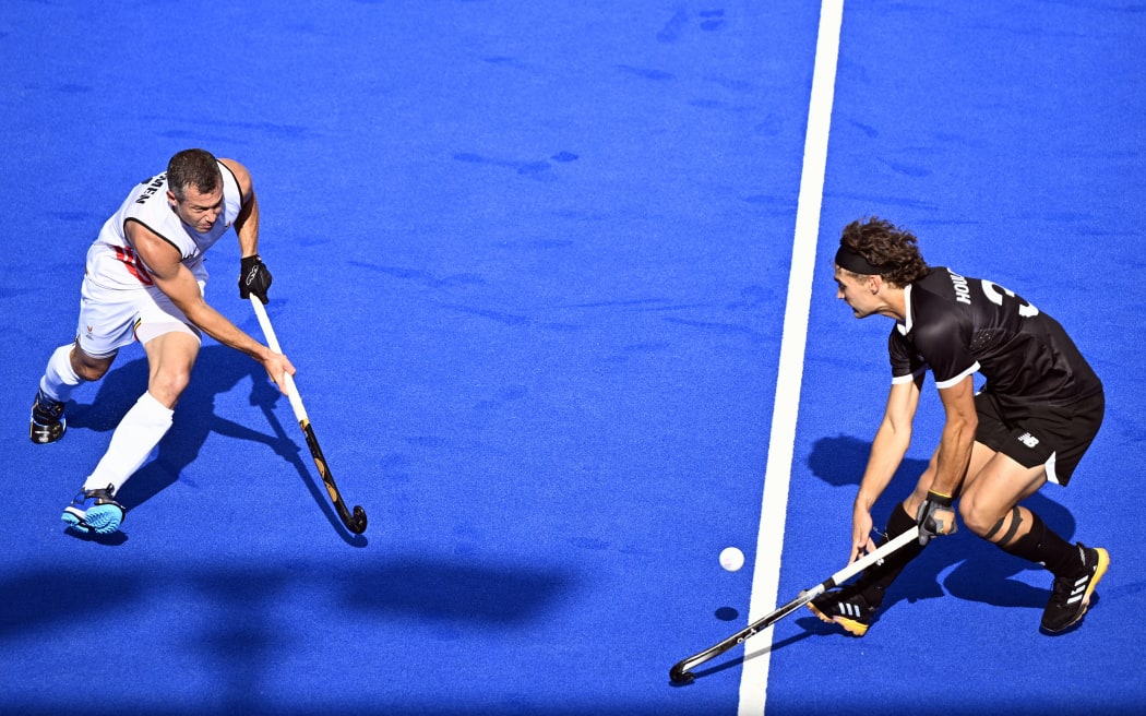 Belgium's John-John Dohmen and New Zealand's Isaac Houlbrooke pictured in action during a hockey game between New Zealand and Belgium's national team the Red Lions, game 2 in the men's pool B at the Paris 2024 Olympic Games, on Sunday 28 July 2024 in Paris, France. The Games of the XXXIII Olympiad are taking place in Paris from 26 July to 11 August. The Belgian delegation counts 165 athletes competing in 21 sports. BELGA PHOTO JASPER JACOBS (Photo by JASPER JACOBS / BELGA MAG / Belga via AFP)