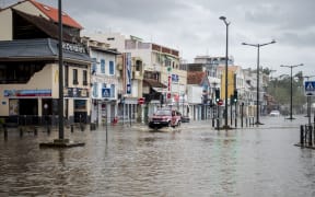 A motorist drives on the flooded waterfront in Fort-de-France, on the French Caribbean island of Martinique, after it was hit by Hurricane Maria, on September 19, 2017