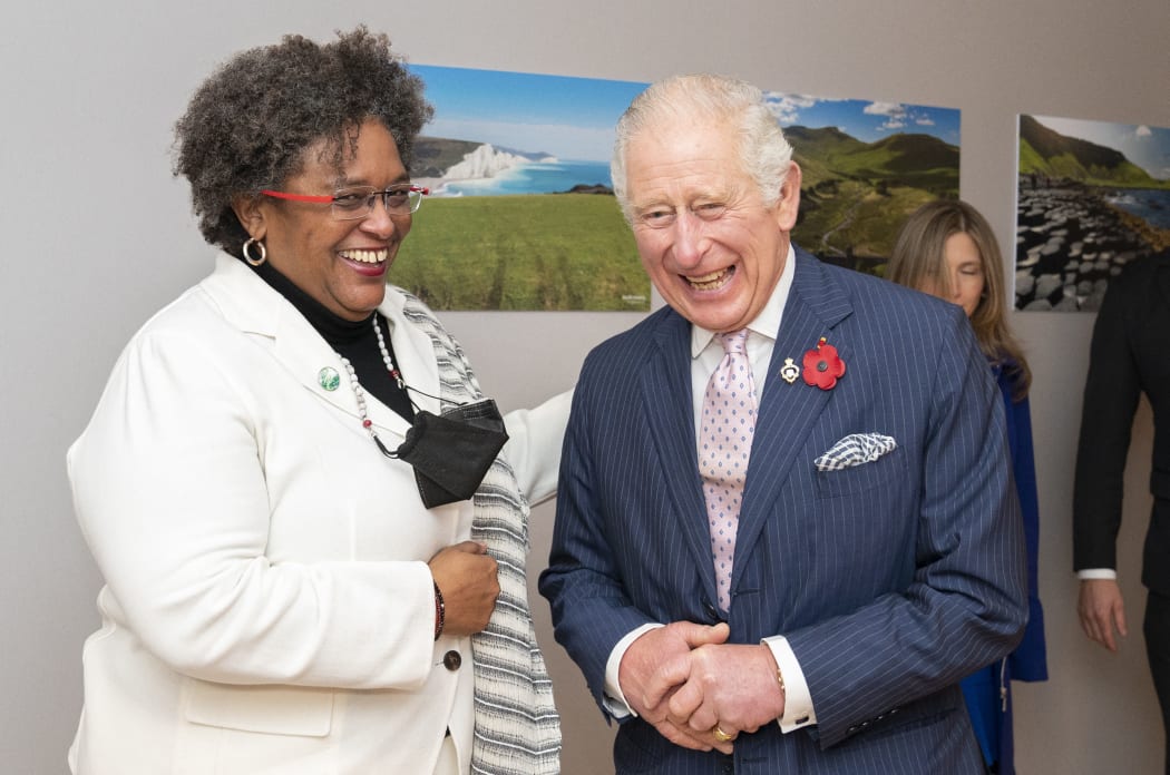 Britain's Prince Charles, Prince of Wales (R) and Barbados' Prime Minister Mia Amor Mottley react during their bilateral meeting on day two of the COP26 UN Climate Change Conference in Glasgow, Scotland