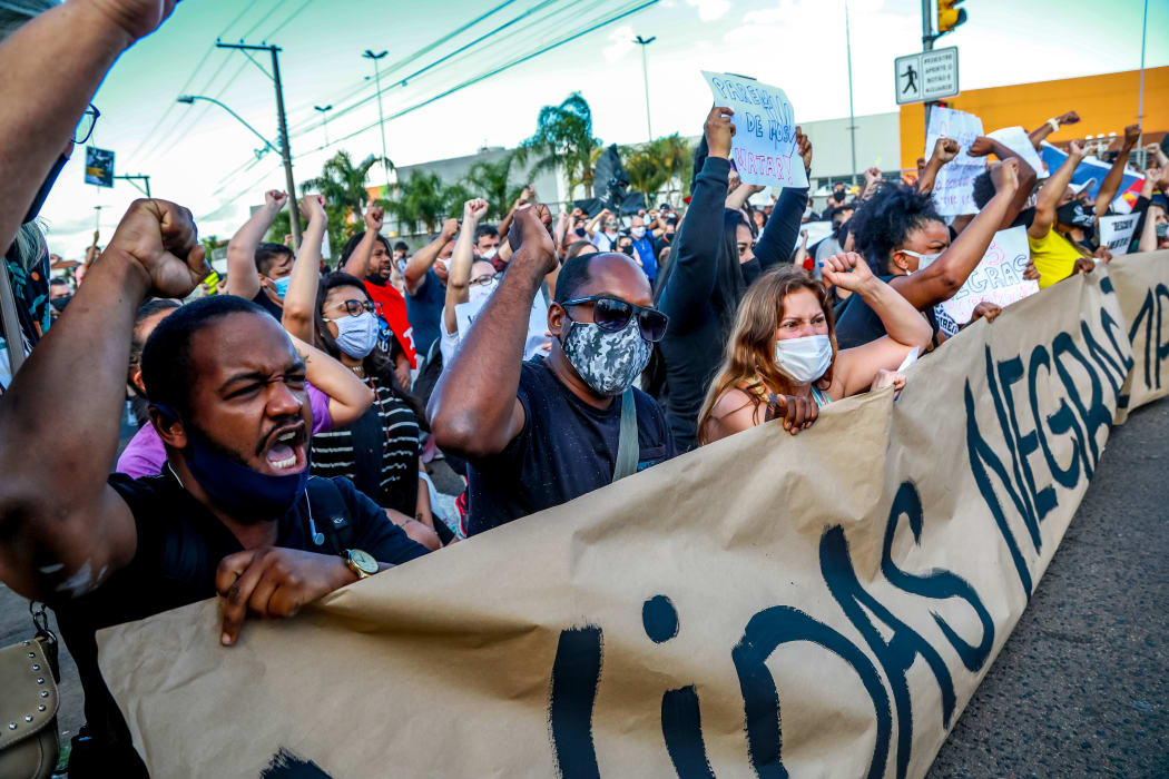 People protest against the death of a black man in front of supermarket Carrefour, where his beating took place, in Porto Alegre, Rio Grande do Sul, Brazil.