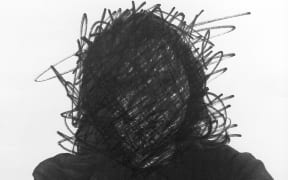 Illustration of face obscured by drawing.