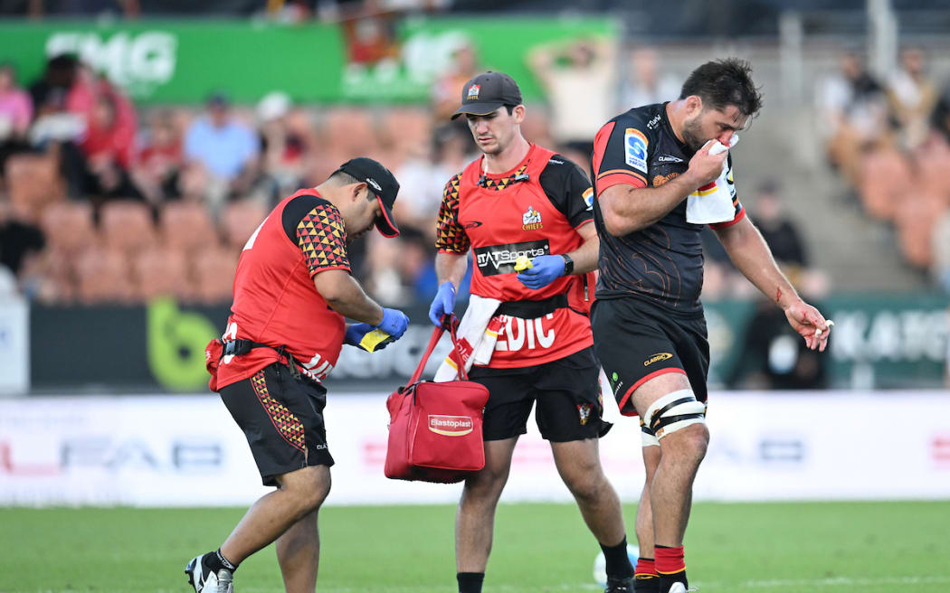 Luke Jacobson leaves the field after a head clash.