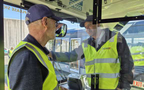 Mayor Wayne Brown poses in front of the driver protection screen.