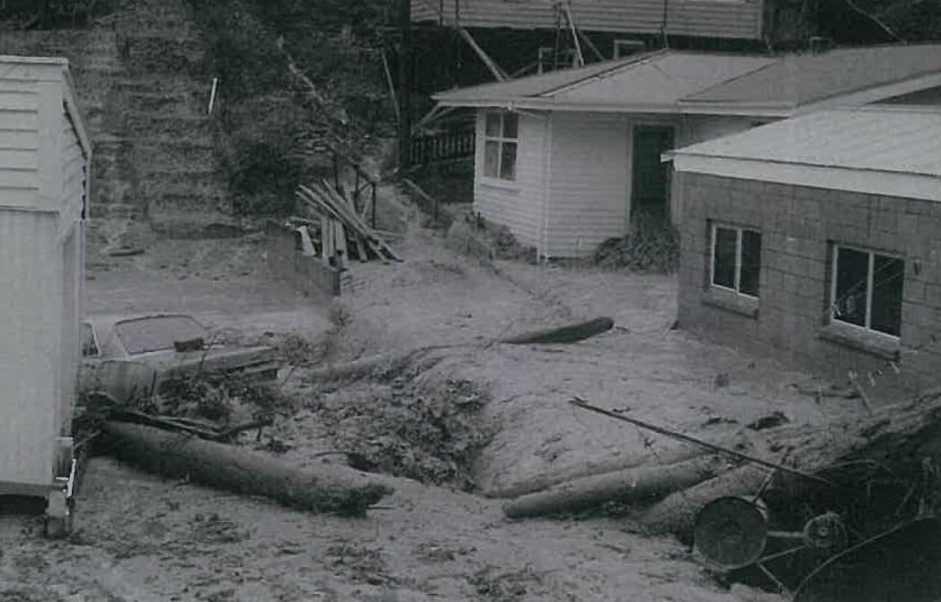 Water courses through propoerties in Pinehaven, Upper Hutt during a 1976 flood.
