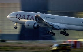 FILE - A Qatar airways plane lands at the airport in Frankfurt, Germany, as the sun rises on Sept. 25, 2023. Twelve people were injured when a Qatar Airways plane flying from Doha to Dublin on Sunday May 26, 2024 hit turbulence, airport authorities said. (AP Photo/Michael Probst, File)