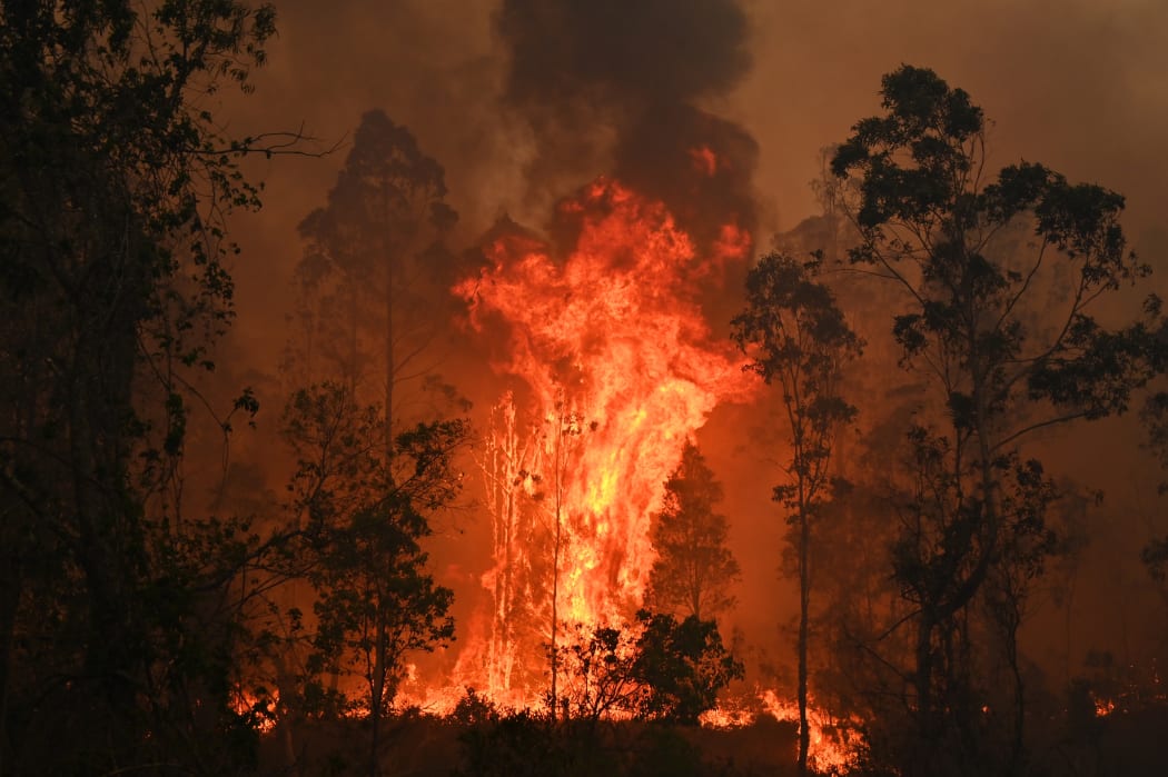 A fire rages in Bobin, 350km north of Sydney on November 9, 2019, as firefighters try to contain dozens of out-of-control blazes that are raging in the state of New South Wales.