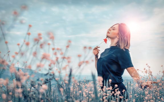 woman with flower in field