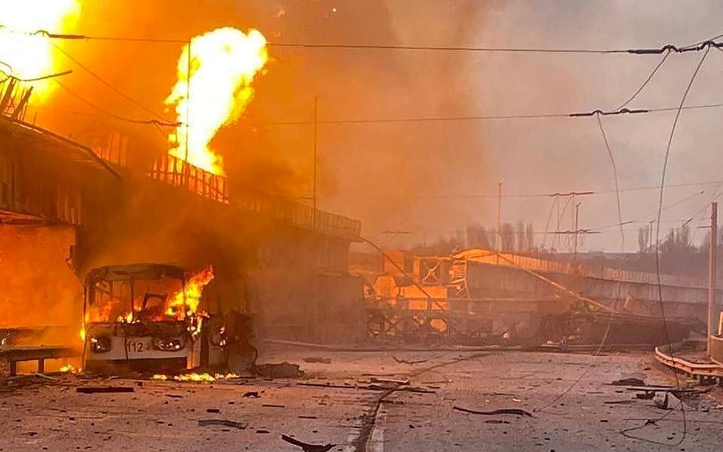 This handout photograph released by Telegram Channel of Ukraine's Prime Minister Denys Shmyhal on 22 March, 2024, shows a burning trolleybus on the dam of Dnipro hydroelectric power plant after a missile attack in Zaporizhzhia, amid the Russian invasion in Ukraine.