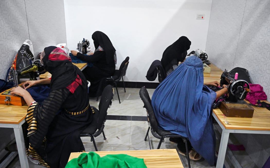 Women work in a tailor workshop at the Khadija Kubra Women's Association for Culture in Kandahar in September 2020,