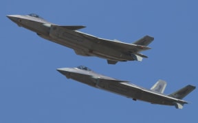 J-20 stealth fighter jets of the Chinese PLA (People's Liberation Army) Airforce fly during a training session in preparation for the 12th China International Aviation and Aerospace Exhibition, also known as Airshow China 2018, in Zhuhai city, south China's Guangdong province, 30 October 2018.