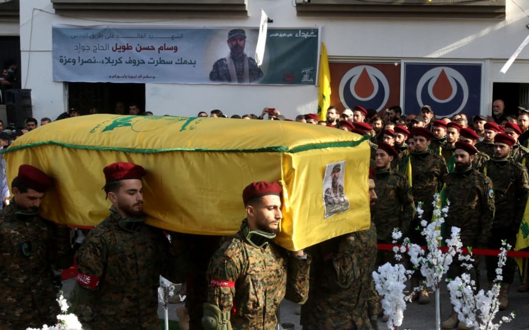 Hezbollah militants carry the coffin of slain Hezbollah military commander Wissam Tawil (Jawad) during his funeral in his hometown village of Khirbet Selm, south of Beirut on January 9, 2024. Hezbollah announced on January 8 the killing of a "commander" for the first time, naming him as Wissam Hassan Tawil. A security souce in Lebanon, requesting anonymity for security reasons, said Tawil "had a leading role in managing Hezbollah's operations in the south", and was killed there by an Israeli strike targeting his car. (Photo by MAHMOUD ZAYYAT / AFP)