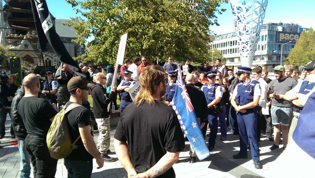 White supremacists hold a flag ceremony in Cathedral Square.