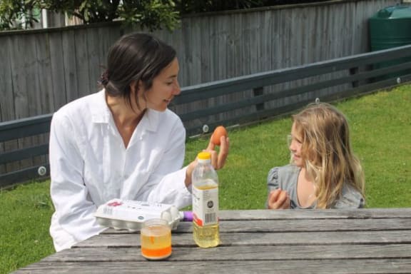 A photo of Michelle and Jessica preparing an experiment