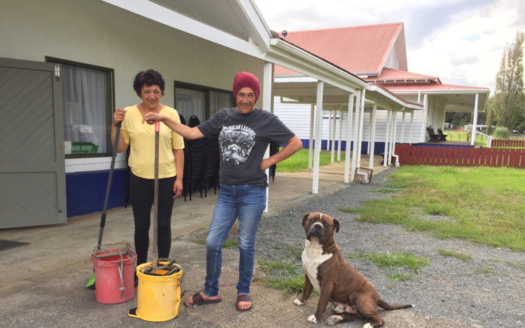 Sister Pepi (left) and Sister Tracy Tau took time out to clean up Hurricane Gabriel floodwaters at the Kehuahikiwe Meeting House for Resilience Assistance.