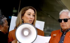 'Sunday' presenter Miriama Kamo speaks at a rally outside TVNZ headquarters in Auckland on 28 March, 2024 as part of a campaign protesting the broadcaster's planned job cuts.