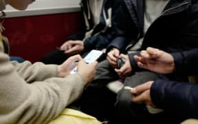 Paris - Teenagers play on their mobile phones in the subway. Photo Eric Beracassat/Hans Lucas
Paris - Des adolescents jouent sur leurs tlphones dans le mtro. Photo Eric Beracassat/Hans Lucas (Photo by Eric Beracassat / Hans Lucas / Hans Lucas via AFP)