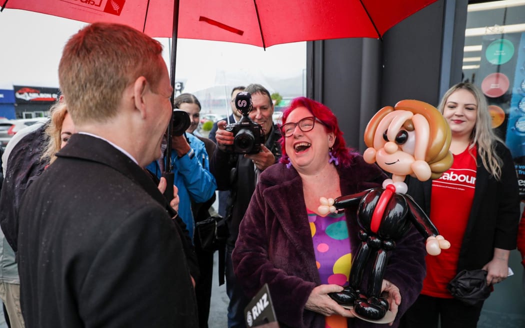 Labour leader Chris Hipkins is greeted by supporters outside a store in Nelson on his walkabout and given a figurine of himself made of balloons on 11 September, 2023.