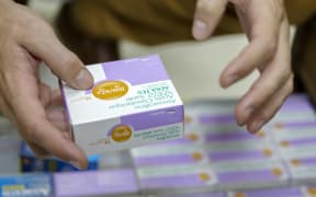 Medication being handed over at a pharmacy