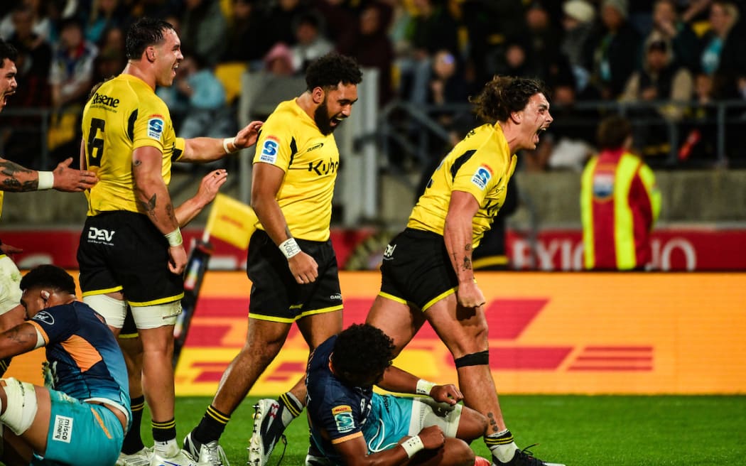 Peter Umaga-Jensen of the Hurricanes celebrates his try.