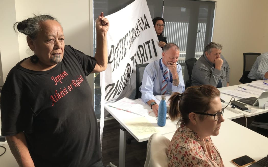 Karakia lobbyists Mirinia Arana-Pou (left) and Careen Davis make their call for karakia to return to open every council meeting clear in a banner for all to see at the 29 March KDC meeting in Mangawhai
