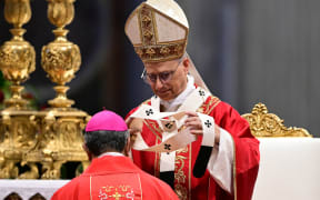 A new archbishop receives the pallium from Pope Leo XIV during a mass on the day of Saints Peter and Paul feast at St Peter's basilica in The Vatican, on June 29, 2025. (Photo by Tiziana FABI / AFP)