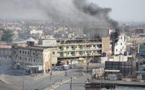 Smoke rises above a building, where Daesh terrorist allegedly were, after Daesh attacks in Kirkuk, Iraq