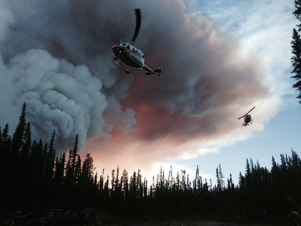 Helicopters tackle the fires.