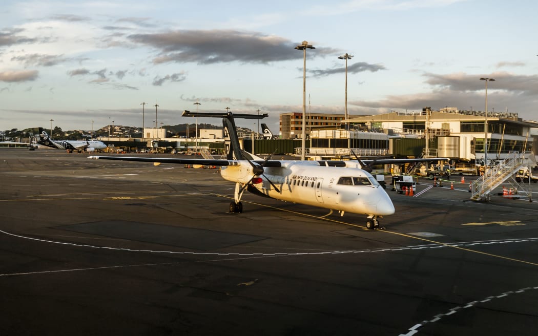 Wellington, New Zealand - January 04, 2019: Aeroplane at the Wellington terminal gate ready for takeoff during sunset on Wellington, New Zealand.