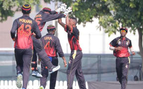 The PNG Barramundis celebrate a wicket.