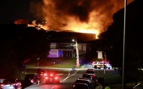 At least 60 residents are lining the streets watching the fire despite Fire and Emergency warning people to stay inside.