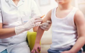 Pediatrician makes vaccination to small boy