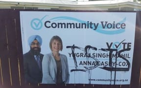 The billboard showing Yugraj Singh Mahil and another candidate Anna Casey-Cox which was defaced and has now been removed.