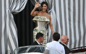 Amazon's founder Jeff Bezos and Lauren Sanchez get on a taxi boat at the Aman Hotel in Venice on June 26, 2026. Celebrities in superyachts sail into Venice this week for the three-day wedding party of Amazon tycoon Jeff Bezos and Lauren Sanchez, despite irate locals who say the UNESCO city is no billionaire's playground. The tech magnate and journalist have reportedly invited about 200 guests to their multi-million dollar nuptials in the Italian city, which are expected to kick off on June 26 and end Saturday with a ceremony at a secret location. (Photo by Stefano Rellandini / AFP)