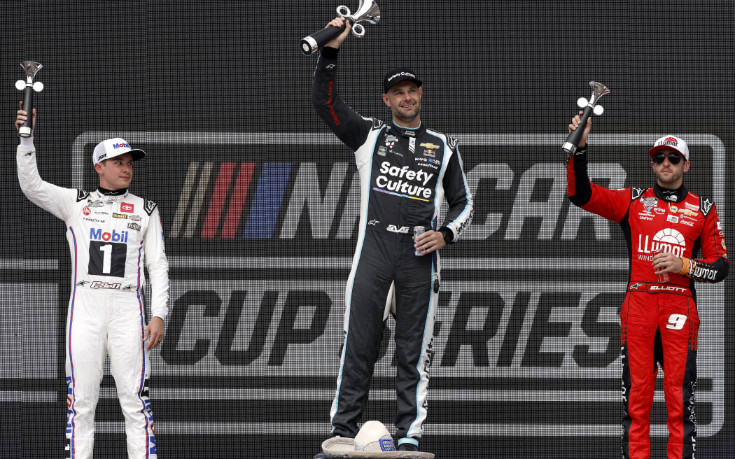 Shane van Gisbergen celebrates on the podium after his win in Mexico City.